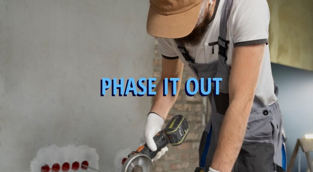 Remodeling in Tacoma’s Stadium District, Browns Point & Old Town Neighborhoods: You NEED to Know This Before You Start 5 Man working on wood cutting it with caption over it reading, 'phase it out' in reference to remodels.
